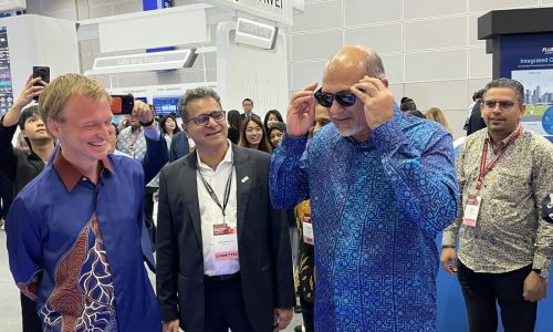 Gobind Singh Deo, Malaysia's Digital Minister trying out AI glasses at an expo in Kuala Lumpur. Photo by Jan Yong